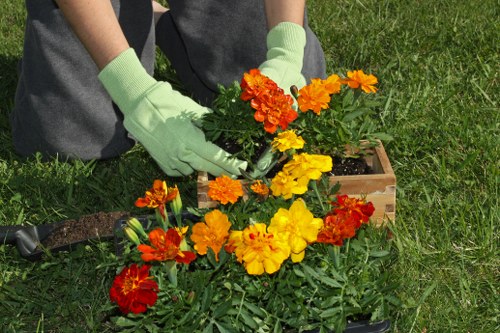 Worker wearing PPE handling gardening tools